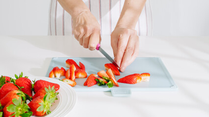 Slicing ripe strawberries for a healthy and fresh snack.