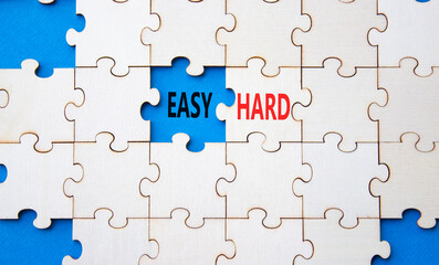 Fototapeta premium Easy or Hard symbol. Concept word Easy or Hard on wooden puzzle. Beautiful blue background. Business and Easy or Hard concept. Copy space