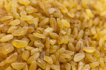Cereal grains of bulgur. Macro shot. Closeup view of cracked wheat. Healthy eco food. Product of organic farming