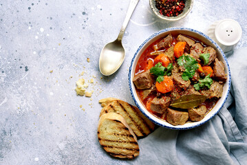 Goulash (meat stew with tomatoes and paprika) - traditional dish of hungarian cuisine .Top view with copy space.