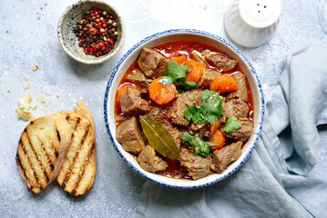 Goulash (meat stew with tomatoes and paprika) - traditional dish of hungarian cuisine .Top view...