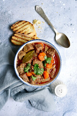 Goulash (meat stew with tomatoes and paprika) - traditional dish of hungarian cuisine .Top view with copy space.