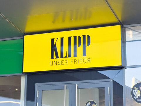 Salon signage for klipp unser frisor on bright yellow background