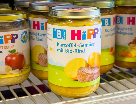 Assorted baby food jars on supermarket shelf displaying hipp brand