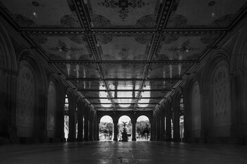 Tourists gather at the Bethesda Terrace in the heart of Central Park in New York City, with the Bethesda Fountain to be recognised in the background. Long exposure.