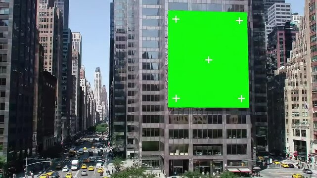 Green screen with tracking markers on the side of a skyscraper in New York City, perfect for visual effects, motion tracking, and compositing in urban and architectural video projects