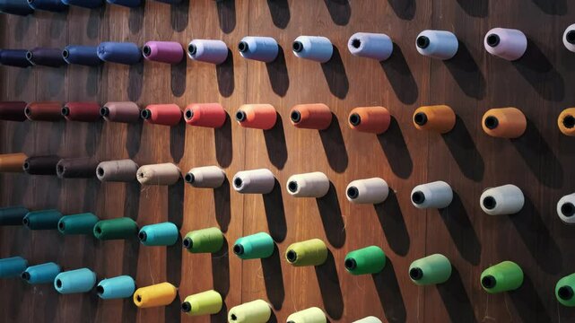 A symphony of colors lined up on a wall. A closer look at the endless variety and beauty of threads, the cornerstone of textiles, fashion and design. Watch the inspiring dance of colors.