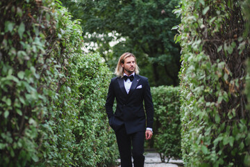 Portrait of handsome young bridegroom with elegant stylish haircut