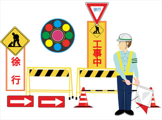 工事現場で交通誘導員が車を誘導している。