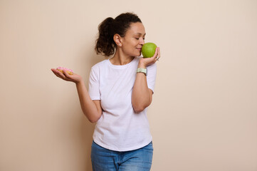 Woman Considering a Healthy Apple Versus Sweet Donut Choice