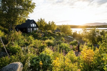 Fototapeta premium Sunset over a vibrant garden beside a serene lake with a person walking amidst the flowers