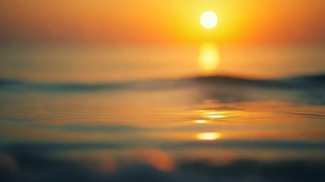 Abstract sea summer ocean sunset nature background. Small waves on golden water surface in motion blur with golden bokeh lights from sun. Holiday, vacation and recreation. Weather and climate change.