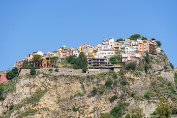 Beautiful view on the hilltop city of Castelmola, a typical sicilian village perched on a mountain, viewed from Taormina in Sicily, Italy  