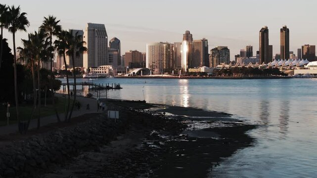 Aerial: Drone Backward Shot Of The Rady Shell Venue By Modern Buildings In Residential City At Sunset - San Diego, California