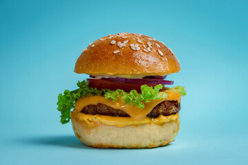 Mini cheeseburger on a vibrant background. 