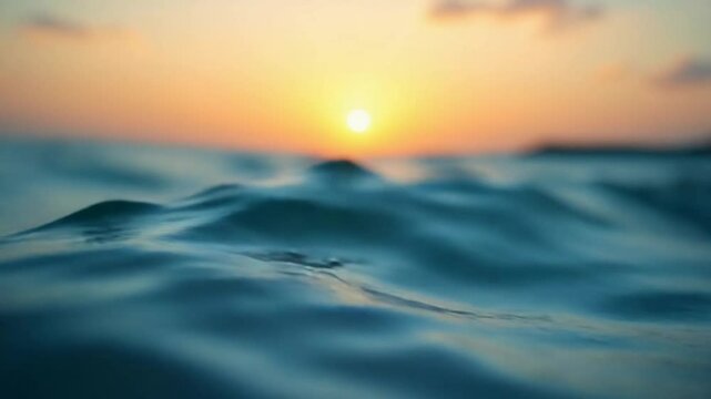 Abstract aerial nature summer ocean sunset sea and sky background. Small waves on clear water surface in motion blur with bokeh lights from sunrise. Holiday, vacation and recreational concept