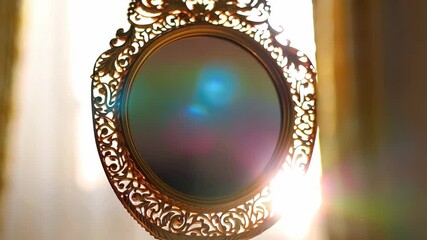 Elegant ornate golden handheld mirror reflecting vibrant rainbow light against soft background, luxurious vintage aesthetic - Powered by Adobe