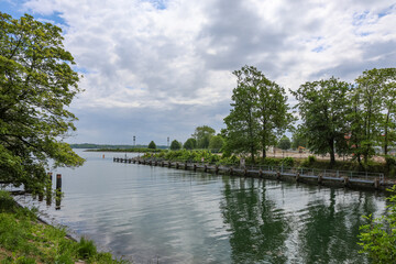 Calm canal ending in Lake Constance on a cloudy day