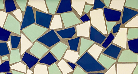 Broken tiles mosaic made with blue and white ceramic pieces background texture for design.Colorful...