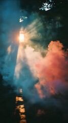 Obraz premium Mystical Smoke and Sunlight: A captivating visual symphony of colorful smoke plumes swirling in a sunlit clearing, with sunlight beams streaming through towering trees.