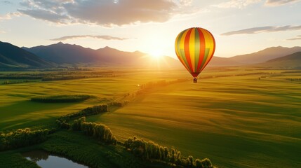 Fototapeta premium Vivid Close-Up of a Floating Balloon Above Scenic Landscape at Sunset