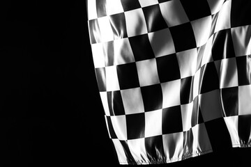 One racing checkered flag on black background, space for text