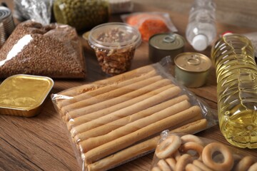 Different food products on wooden table, closeup