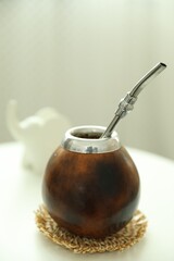 Traditional yerba mate tea on white table indoors, closeup