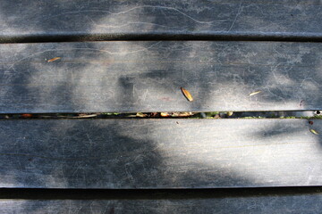 A weathered park bench surface close up