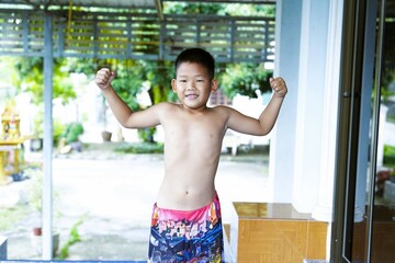 The boy took off his shirt and confidently showed off his biceps.