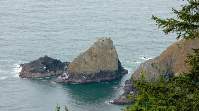 Tillamook Rock stands isolated off Tillamook Head, Oregon, with the decommissioned Tillamook Rock Lighthouse, historically called Terrible Tilly, atop it.