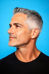 Obraz premium Conceptual art drawing of style for aging men. A peaceful and content male enjoying his portrait. Blue solid background. Modish men's fade haircut - midlife arabian man with short hair.