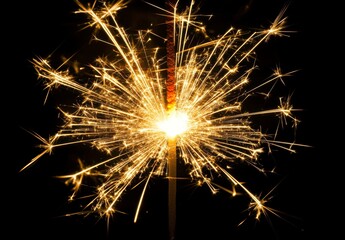 Bright Sparkler Igniting in Dark Background Creating Glowing Sparks
