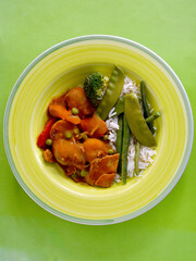 Chicken and potato curry with vegetables and steamed white rice. 