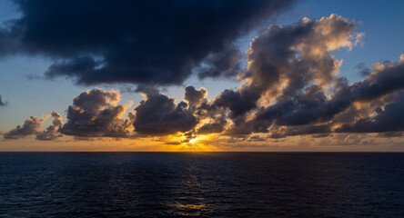 Dramatic Sunset Over Clouds Illuminating Pacific Ocean Horizon