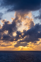 Dramatic Sunset Over Pacific Ocean With Colorful Cloudscape and Sun Rays