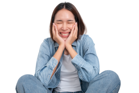 A portrait of young Asian female wear blue jean are sitting on ground with smile cheerful face isolate on white - Powered by Adobe