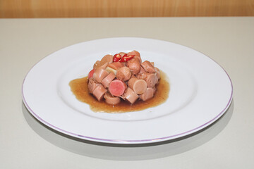 A plate of delicious stir-fried sausages. restaurant dish stir-fried sausages