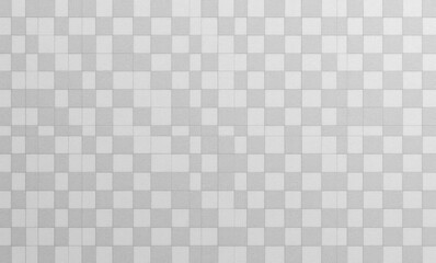 Minimalistic gray and white checkerboard pattern on a textured background.