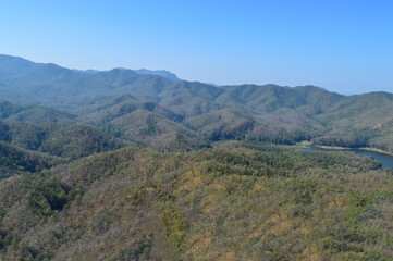 Fototapeta premium Distant Mountains and Forest with Trees and Sky in Northern Thailand.