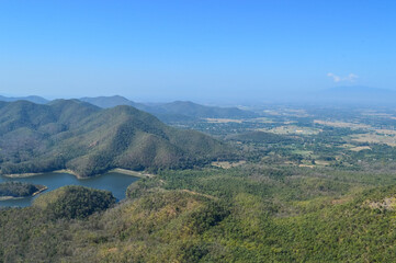 Obraz premium Distant Mountains and Forest with Trees and Sky in Northern Thailand.