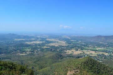 Obraz premium Distant Mountains and Forest with Trees and Sky in Northern Thailand.