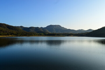 Mountains and Cloud Sky Reflect on Lake Water.