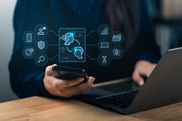 Close-up person hand engages with a smartphone and a laptop, displaying AI technology and data visualization. The scene represents modern workspace innovation and digital communication.