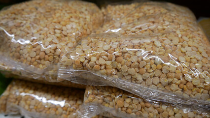 Close-up of many pea groats packages on a store shelf