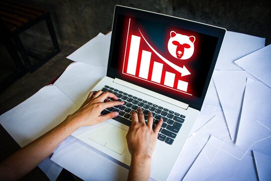 Bear market decline icon on laptop screen, showing downward financial trend, investment losses, and stock pessimism. Ideal for crisis, risk analysis, and economic downturn illustrations.