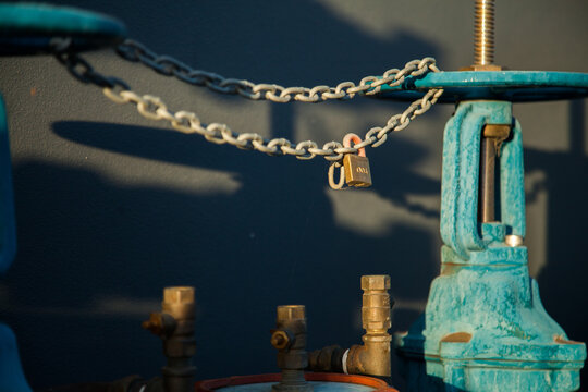 Lock on wheels and chains on a blue water hydrant