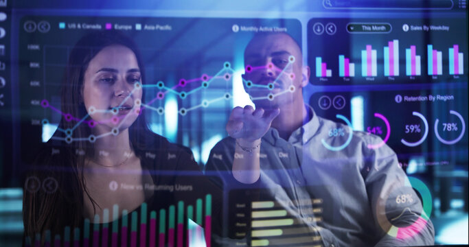 Man And Woman Analyzing Financial Data On Holographic Office Dashboard