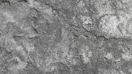 A rough, gray concrete wall texture shows a textured surface with a grunge pattern
