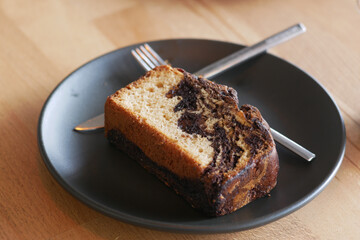 Delicious marble cake served on a black plate